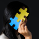 Is Pathological Demand Avoidance : Pervasive Need for Autonomy (PDA) Related to Autism?, image of girl hiding face with jig saw puzzle.