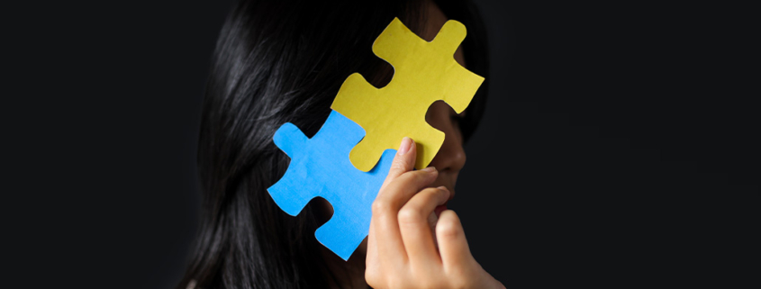 Is Pathological Demand Avoidance : Pervasive Need for Autonomy (PDA) Related to Autism?, image of girl hiding face with jig saw puzzle.
