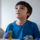How Long Does It Take to Get Diagnosed with Autism, image of a young kid looking up.
